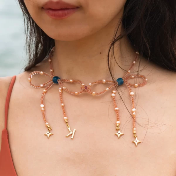 women’s handmade orange pink bead necklace with charms